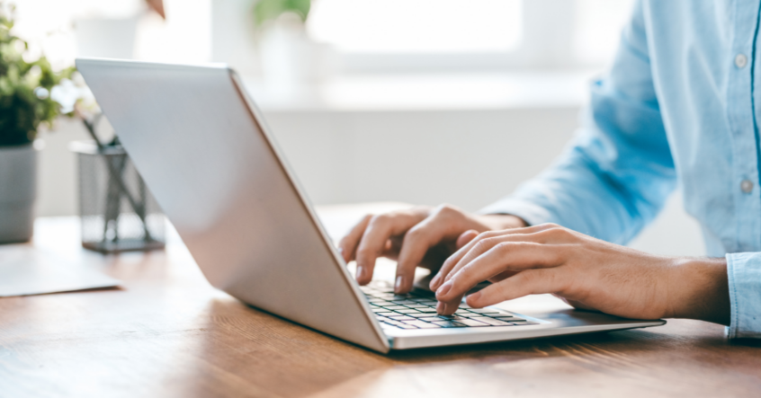 person typing on a laptop