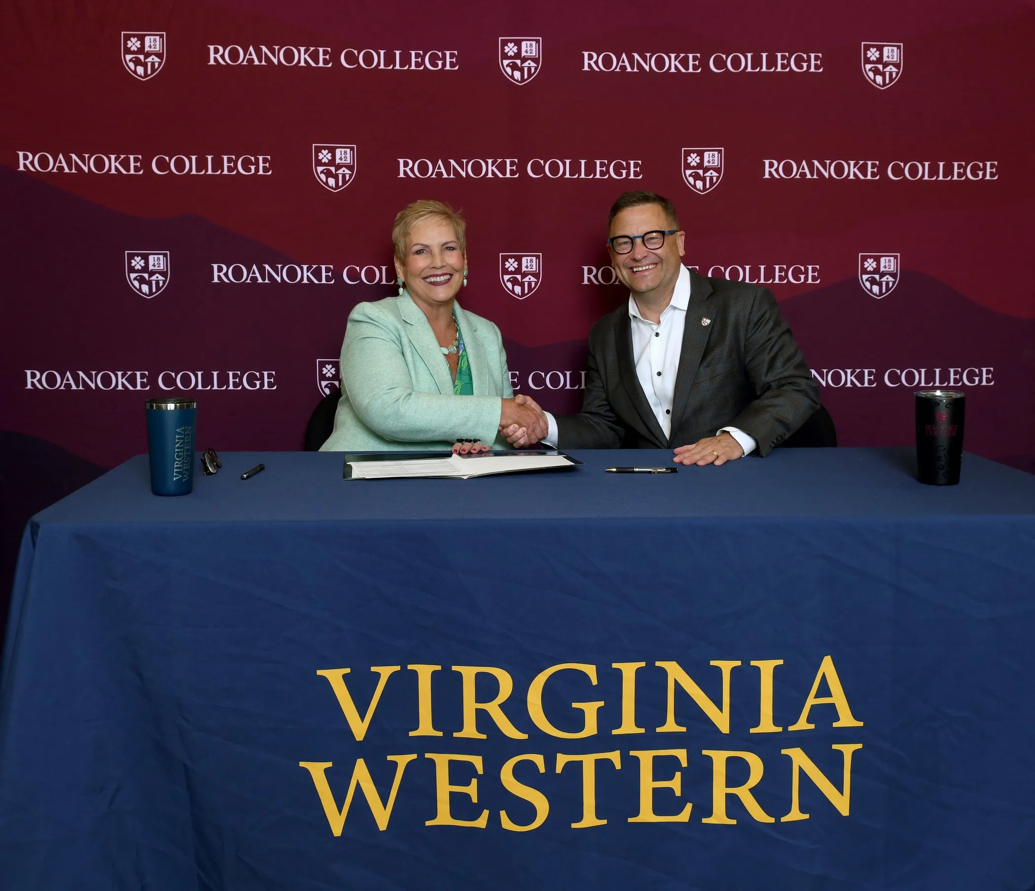 Virginia Western President Laura Treanor and Roanoke College President Frank Shushok Jr. celebrate the new agreement.